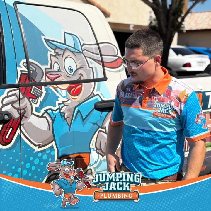 Jumping Jack Plumbing technician beside branded service truck