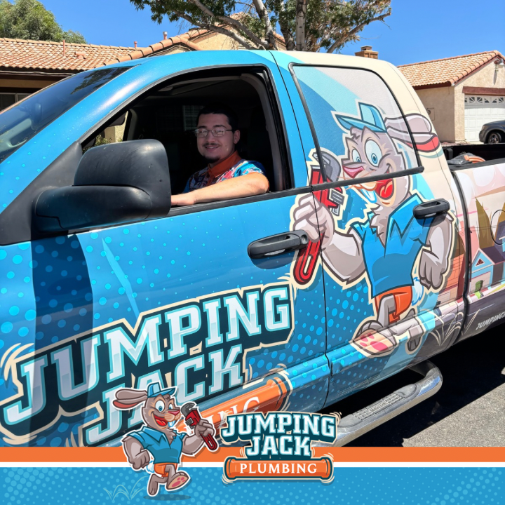 Jumping Jack Plumbing technician in the branded service truck
